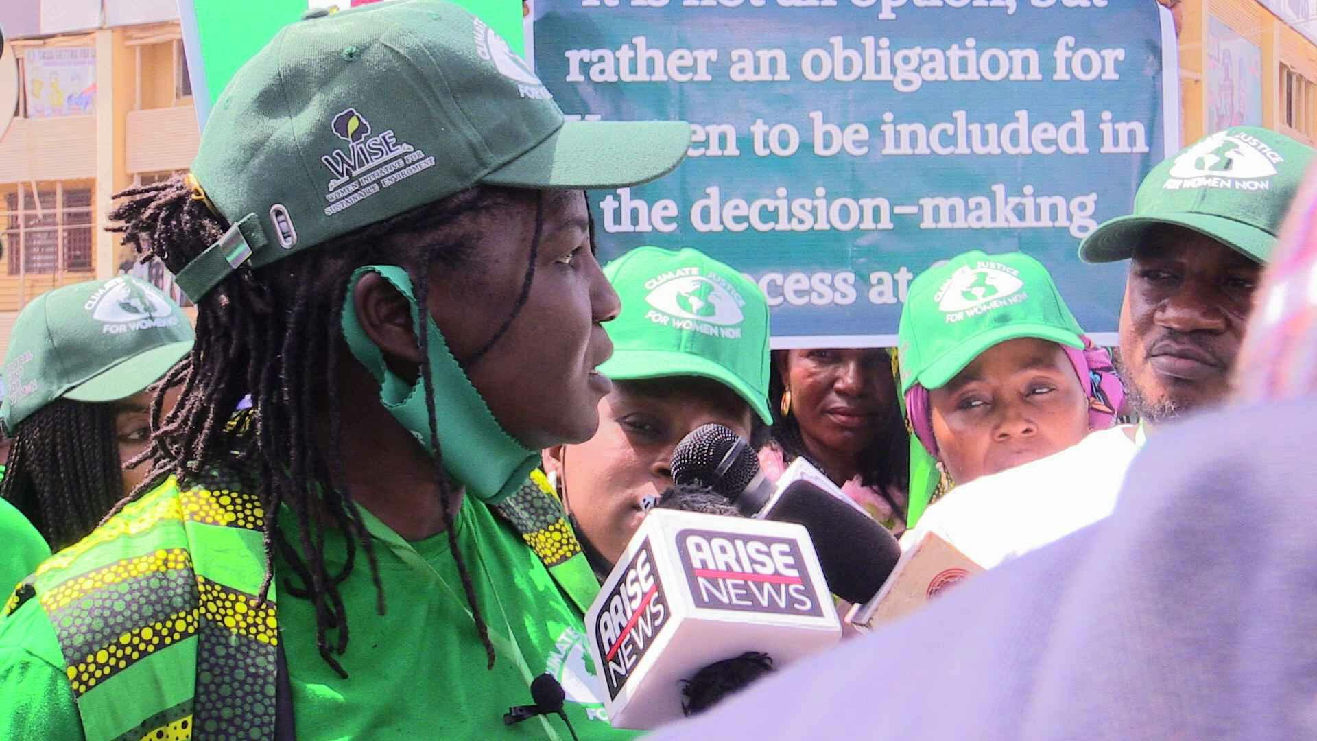 Olanike addressing journalists during a Pre COP28 rally organized and led by an organization she founded and leads.