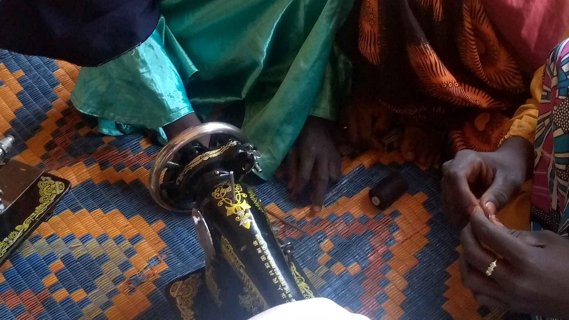 Girls living with disabiliities during a class in tailoring